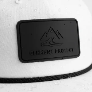 Matte silicone rubber patch on a performance hat, representing modern, waterproof branding for outdoor and golf.