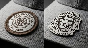 Macro view of a custom rectangular woven patch with a detailed compass logo and brown merrowed edge on a charcoal grey baseball cap.