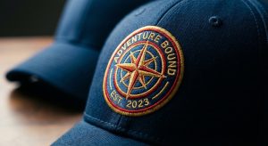 Close-up of a high-quality circular embroidered patch sewn onto a navy blue structured baseball cap.