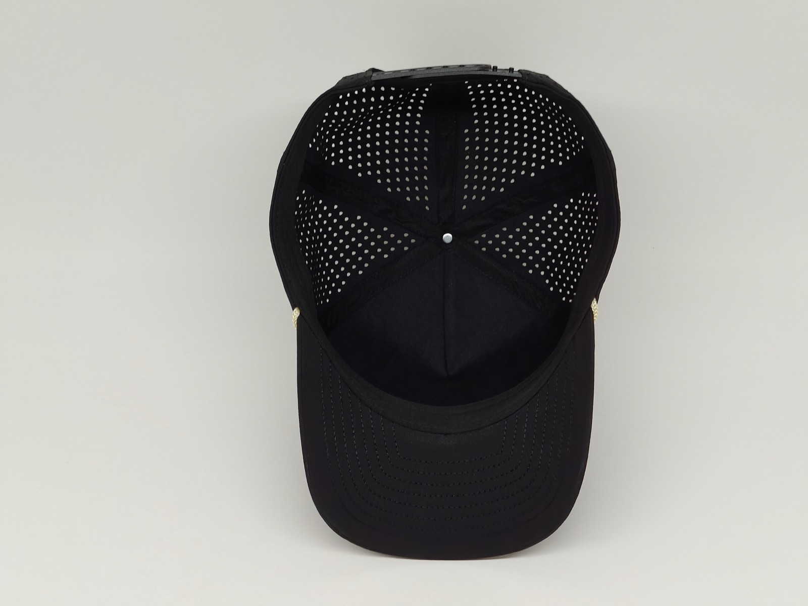 Interior of an unlabelled black cap sample showing sweatband and crown seam positions
