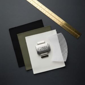 Deconstructed view of a $45 streetwear hat showing premium fabric swatches, zinc alloy buckle, and buckram mesh.