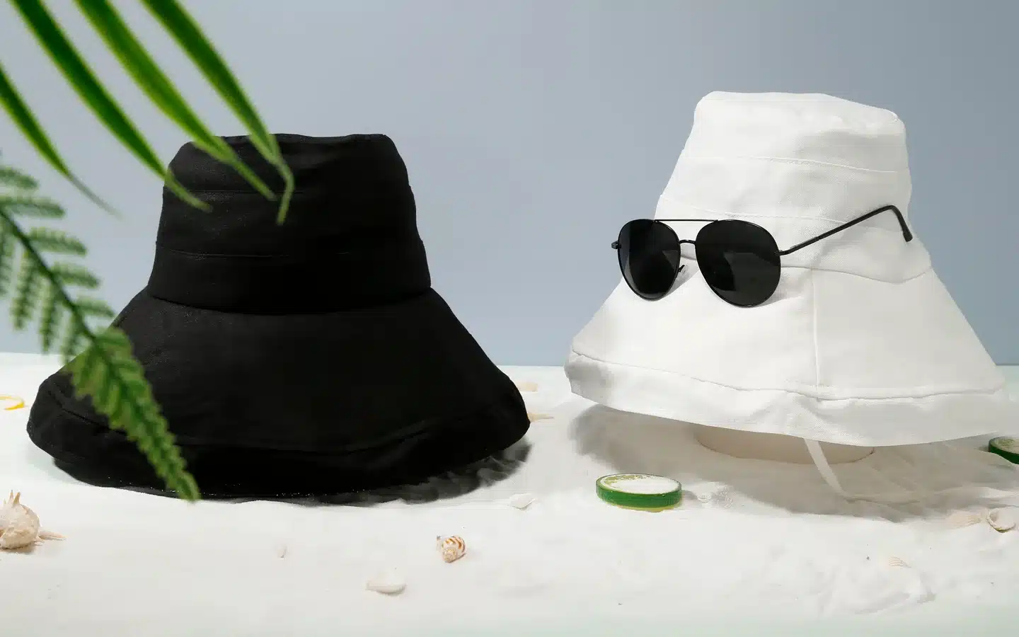 Black and white custom bucket hats displayed in a lifestyle setting