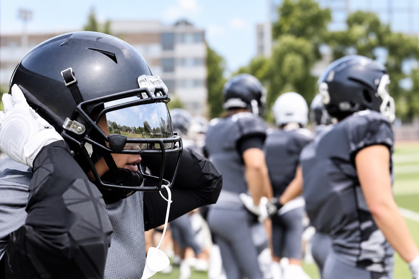 Generic American football players preparing on the sideline