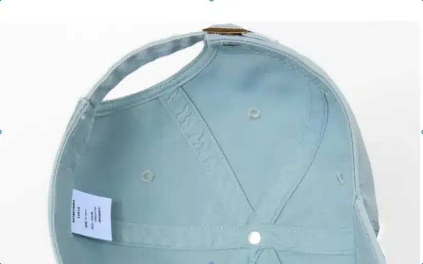 Inside view of a light blue cap showing crown seams, sweatband and internal label placement
