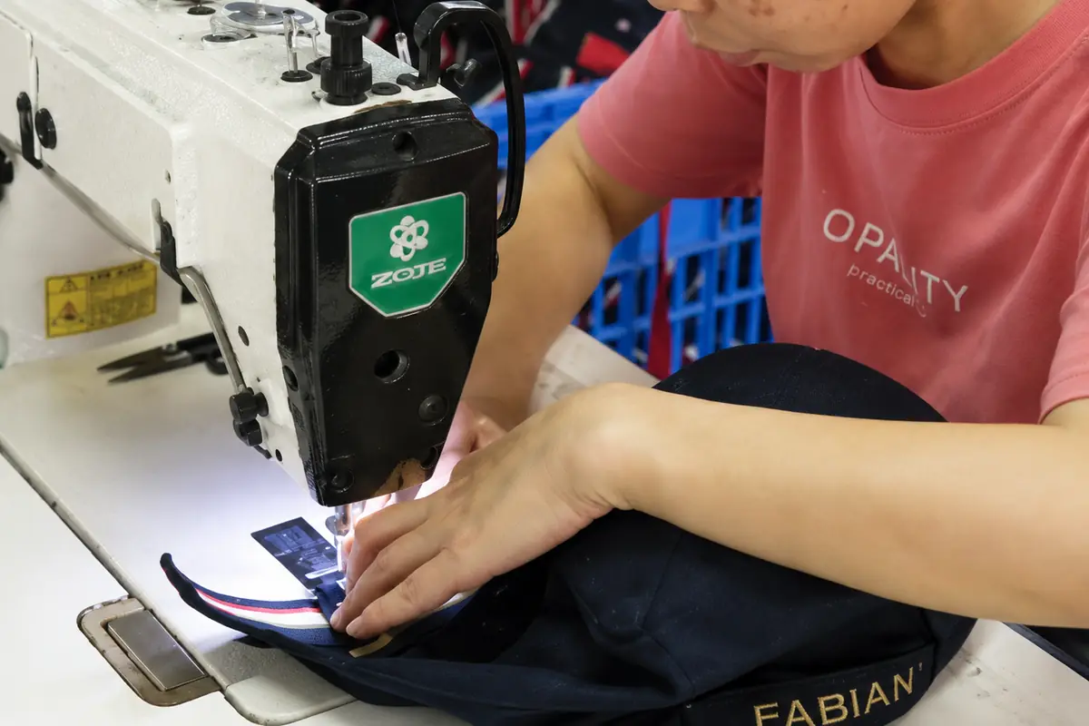 Custom hat panels being sewn during bulk production