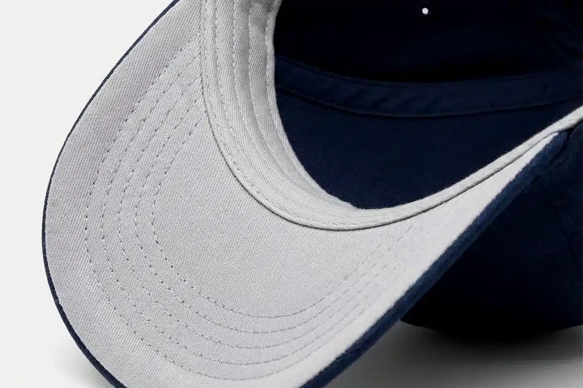 Interior crown and sweatband construction of a structured navy cap