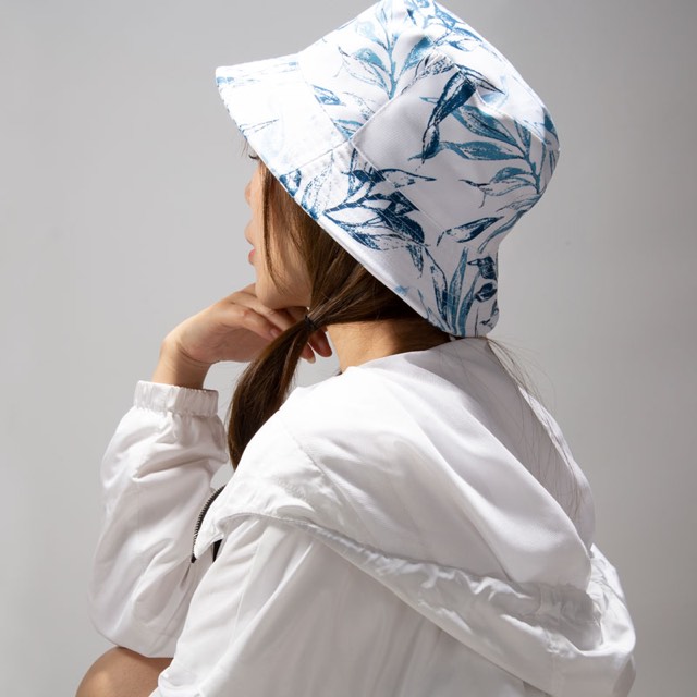 Side view of a person wearing a blue-and-white printed bucket hat, showing crown position and brim angle