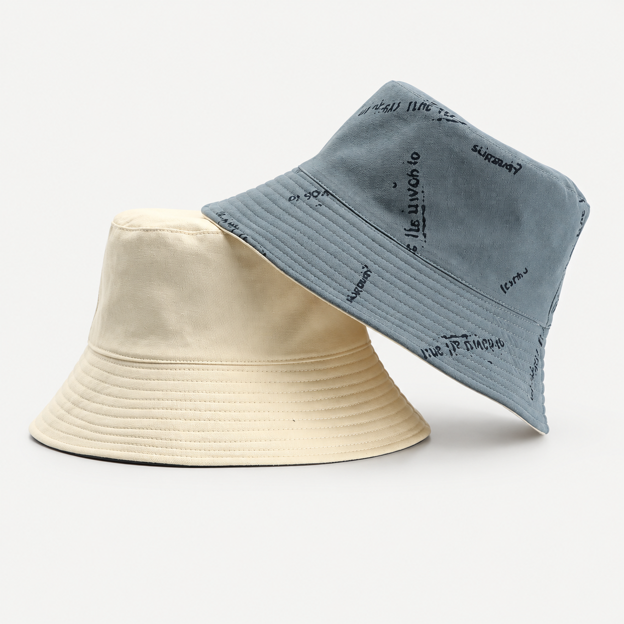 Reversible bucket hat shown in two neutral color combinations